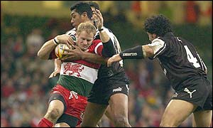Wales' Paul Atcheson is tackled by New Zealand's defence