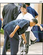 Security official checks a woman