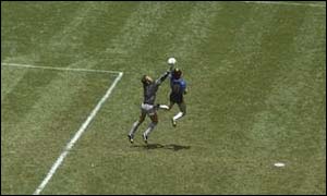 Argentina's Diego Maradona beats England goalkeeper Peter Shilton to the ball with his hand
