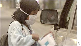 Girl sells masks on Colon Av. in Quito, Ecuador