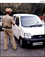 Members of the Rajasthani Police search vehicles at the entrance to one of Delhi's markets.