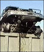 Wrecked jeep on truck after explosion