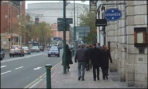People walk past pubs in Birmingham's Broad Street
