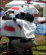 Men in helmets held the helicopter down