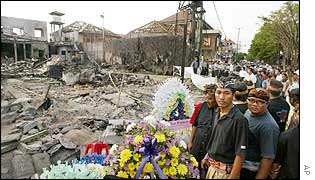 Balinese residents look at site of the destroyed Sari nightclub