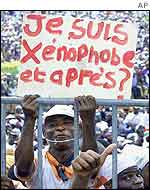 Government supporter with a sign reading: 'I'm xenophobic, so what?'
