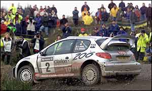 Didier Auriol races his Peugeot pastfans on last year's Rally of Great Britain