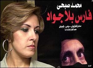 A woman walks past a poster for Horseman Without A Horse