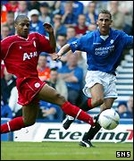 Peter Lovenkrands takes on Aberdeen's Eric Deloumeaux