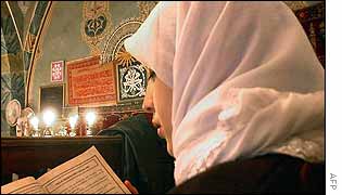 A Turkish girl reads the Koran at the Hadji Bayram mosque in Ankara