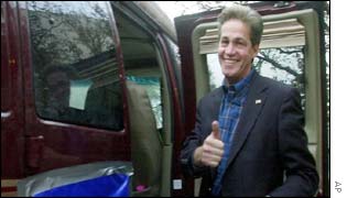 Senator-elect Norm Coleman gives the thumbs up as he leaves the Republican election night party HQ