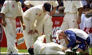 Simon Jones writhes in pain as England physio Kirk Russell attends to him