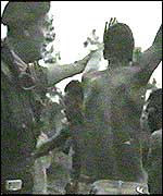 Suspects being checked for the mark of the Mau Mau