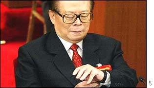 Jiang Zemin checks his watch after delivering his speech at the congress