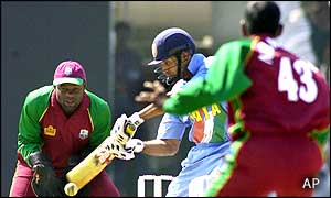 India's V VS Laxman (centre) flicks the ball as West Indies' wicket-keeper Ridley Jacobs looks on