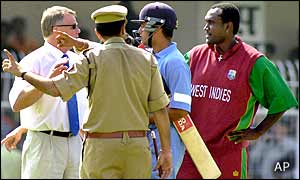 Both team captains and match umpire Mike Proctor show police which area of the ground missiles were thrown from