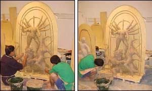 The craftsmen smooth on the first layer of clay