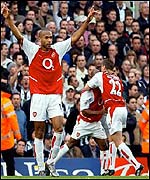 Thierry Henry celebrates Arsenal's winner while goalscorer Sylvain Wiltord is congratulated by Oleg Luzhny