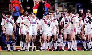 The British players stand under the posts as New Zealand prepare to convert one of their tries