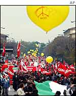 Marchers carrying red banners 