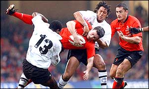 Stephen Jones is tackled by the Fijian defence