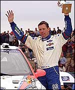 Colin McRae celebrates after another victory