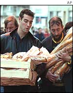 Calais residents bring bread to the church
