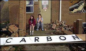Children sit on the steps of their destroyed school in Carbon Hill, Alabama