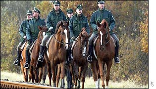Police officers on their horses patrol the railway tracks near Dannenberg, northern Germany