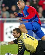 FC Basle's Gimenez beats Liverpool goalkeeper Jerzy Dudek to score