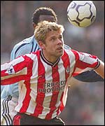 James Beattie wins a header against Manchester City