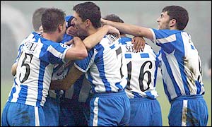 Roy Makkaay is swamped by Deportivo team-mates after his winner