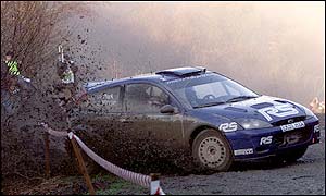 Markko Martin's Ford is second behind Marcus Gronholm's Peugeot