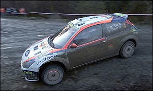 Colin McRae's Ford Focus slides through the mud at the Rally of GB