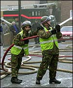 Members of the armed forces attend a fire