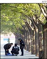 Man having his bag searched near the Great Hall of the People in Beijing