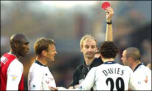 Mike Riley brandishes the red card for Spurs midfielder Simon Davies