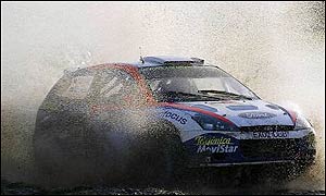 Colin McRae drives his Ford Focus through the water in Magram Park.