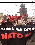 Czech anarchists carry a banner reading Nato - Death for Sale