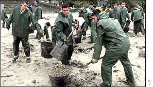 Clean up operation on beach in north west spain 