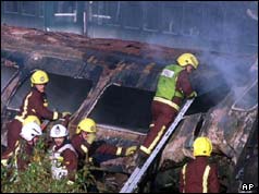 05/10/1999 Firemen climb on the smouldering wreckage of one of the railway carriages
