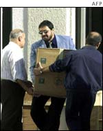 UN employees and arms inspectors deliver equipment