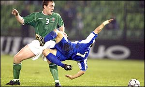 Republic of Ireland defender Richard Dunne is tackled by Stylianos Giannakopoulos of Greece during the first half