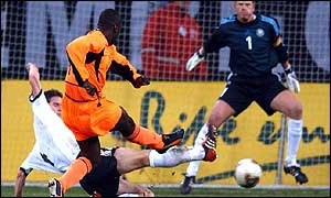 Jimmy Floyd Hasselbaink overcomes Arne Friedrich to score for Holland
