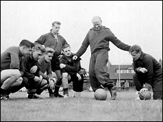 Sir Matt Busby (centre, standing) with players in 1956