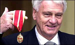 Bobby Robson smiles for the cameras after receiving his knighthood 