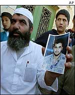 Father of alleged bomber shows picture of his son