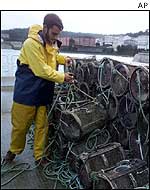 Fisherman stacks up shrimp pots