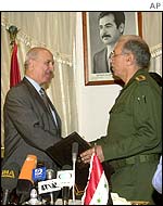 Iraqi Oil Minister Aamer Mohamed Rashid, right, shakes hands with Jordanian Energy Minister Mohamed al-Bataina