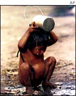 A malnourished child in Delhi tries to cool down.